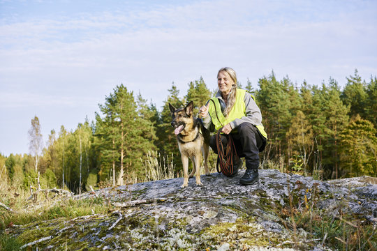 Sweden, Uppland, Rison, Portrait of volunteer with dog helping emergency services find missing people