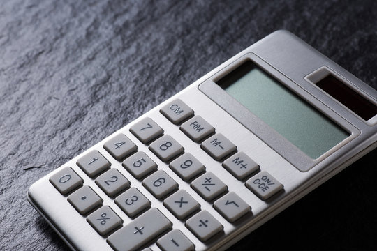 silver calculator on black background