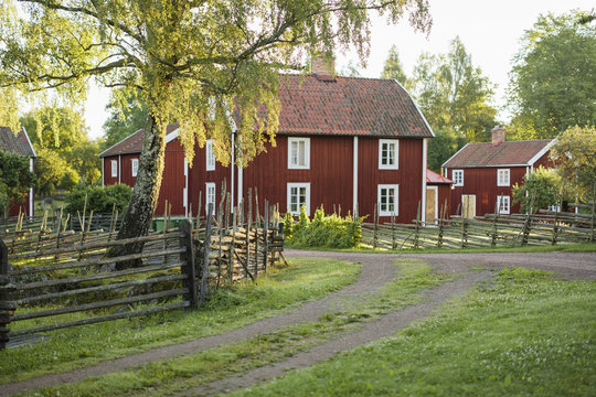 Sweden, Smaland, Stensjo, Wooden village among trees