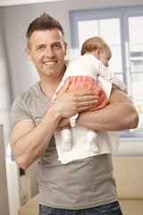 Handsome father holding baby girl