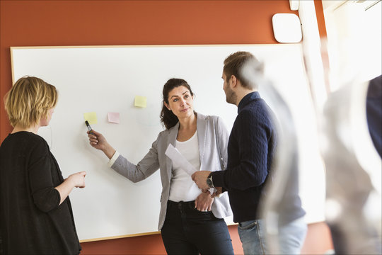 Sweden, People sharing ideas during work meeting
