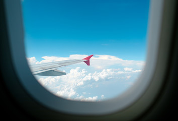 View of beautiful cloud and wing of airplane from window