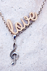 silver music necklace with love wooden letters
