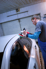 Preparing the car for sale at a service station.