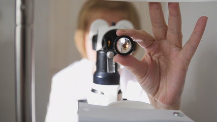 Optometrist - doctor ophthalmology examining patient's eyes - medical concept