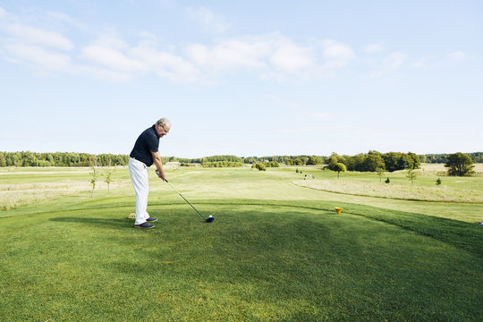 Senior man playing golf on a golf course