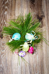 Easter eggs with flowers on wooden background. Toned image