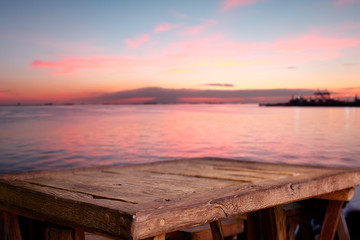 Empty Top of wood table with blurred Twilight sea background. For Product display montage. Beach in summer Concept.