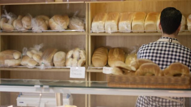  Portrait happy couple business owners behind the counter in bakery shop