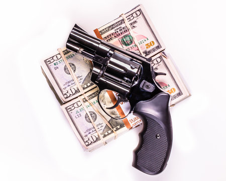 hand gun and stacks of $50s