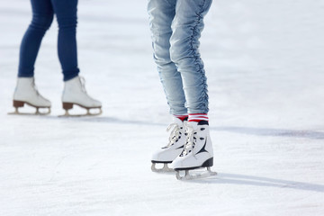 feet skating on the ice rink