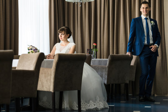 bride and groom in restaurant near the table