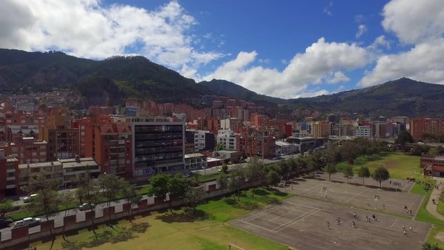 Aerial shot, Bogota's architecture, drone flying over city on background mountains 4K