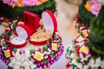 Dowry (gold necklace) on flower tray in Thai traditional wedding