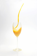 splash of orange juice in the glass on white background