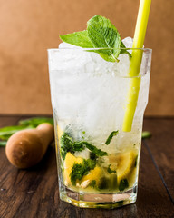 Mojito cocktail with lime, mint leaves and ice.

