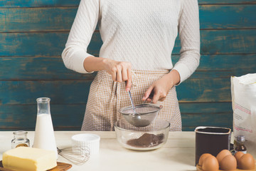 House wife wearing apron making. Steps of making cooking chocolate cake.