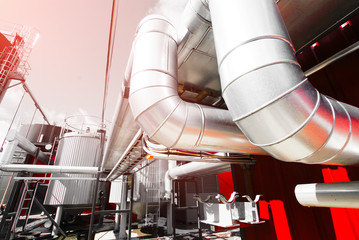Industrial zone, Steel pipelines and valves against blue sky