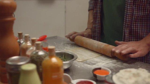 Man kneading dough with roller knead