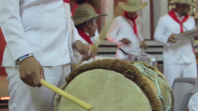 Man playing leather wooden drum