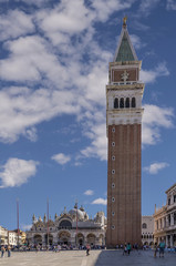 Beautiful vertical view of Piazza San Marco square in a moment of tranquility on a sunny summer day, with a picturesque sky, Venice, Italy
