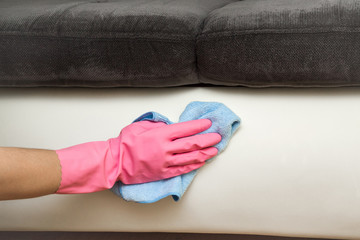 Leather area cleaning with rag. Textile and leather sofa professionally chemical cleaning. Upholstered furniture. Early spring cleaning or regular clean up.