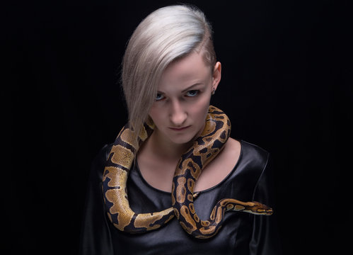 Woman in leather dress and ball python