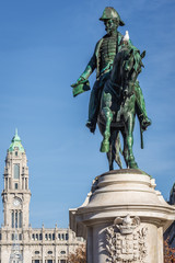 Fototapeta na wymiar Statue of King Peter IV on Liberdade Square in Porto, Portugal. City Hall on background