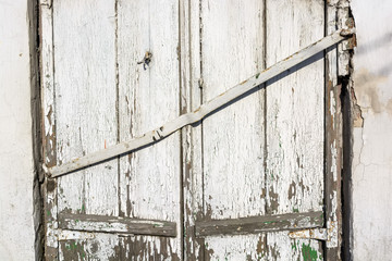Old boarded-up window on brick wall