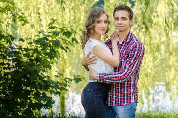 Fototapeta premium A young romantic couple in love in the city park.