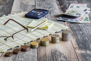 Money on the wooden table. Euro coin stocks from different countries.