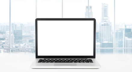 Laptop on table in office with panoramic view of modern downtown skyscrapers at business district