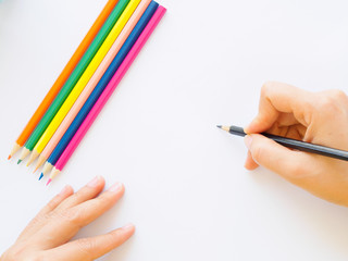 Woman hand with pencil writing on white paper