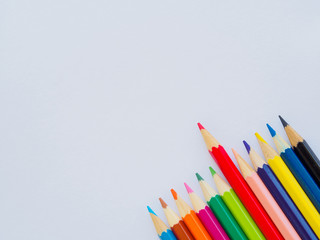 Color pencils on white paper. Education material back to school, for background and wallpaper.