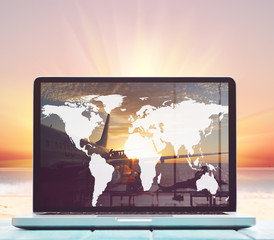 Modern laptop on blue wooden table with blank screen at tropical beach. Elements of this image furnished by NASA