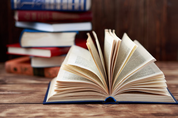 Many old books on wooden background. The source of information. Open book indoor. Home library. Knowledge is power