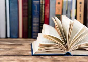 Many old books on wooden background. The source of information. Open book indoor. Home library. Knowledge is power