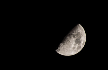 half moon on dark black night sky