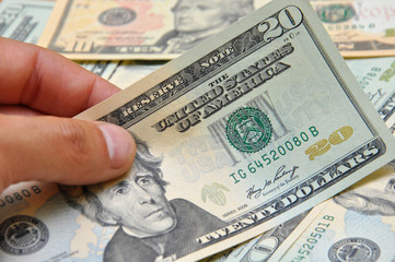 Man hand holding twenty dollar banknote