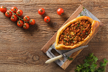 Turkish pide pizza with meat and cheese.