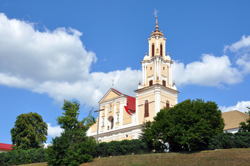 Fototapeta na wymiar Bernardine Church and Monastery in Baroque style against the blue sky in Grodno, Belarus.