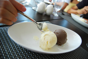 Eating two scoops of vanilla and chocolate ice cream