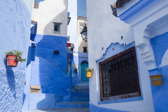 Alley with Flowerpots and Stairs in the Medina of Chefchaouen