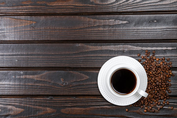 Top view of coffee cup on a wood background with copy space.