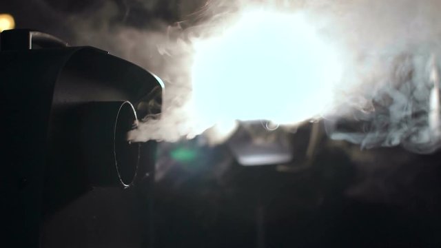 Smoke machine and studio light close-up. Smoke machine in action, slow motion.