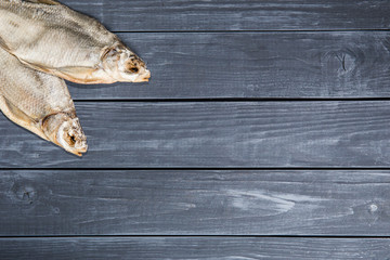 Dried bream on a wooden table. Copyspace for text.