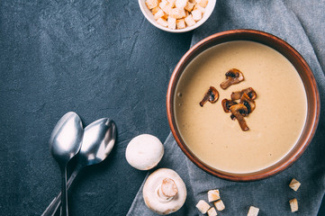 Cream soup of mushrooms on a dark background