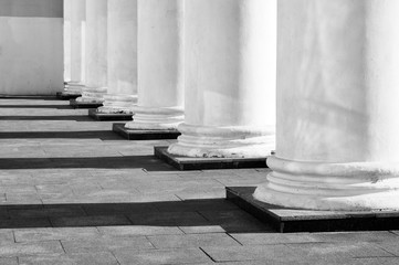 White classical column bases with contrasting shadows in perspective. Architectural geometric black...