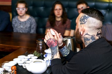 The bearded man participates in the tea ceremony