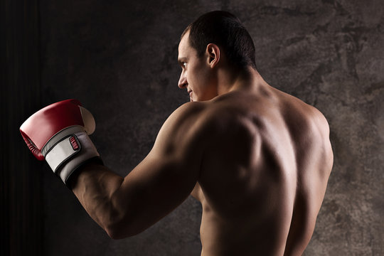 Young muscular man boxer, boxing gloves